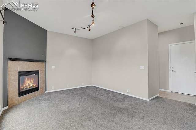 9344 Hirono Rd, Peyton, CO 80831 - unfurnished living room with carpet flooring, rail lighting, and a fireplace