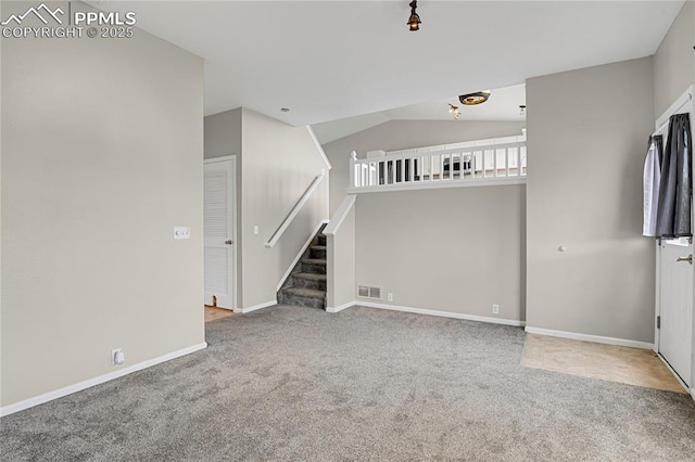 9344 Hirono Rd, Peyton, CO 80831 - unfurnished living room featuring carpet floors, stairway, and lofted ceiling