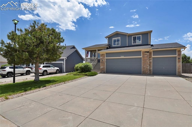 9344 Hirono Rd, Peyton, CO 80831 - view of front of property with concrete driveway, stone siding, and a garage