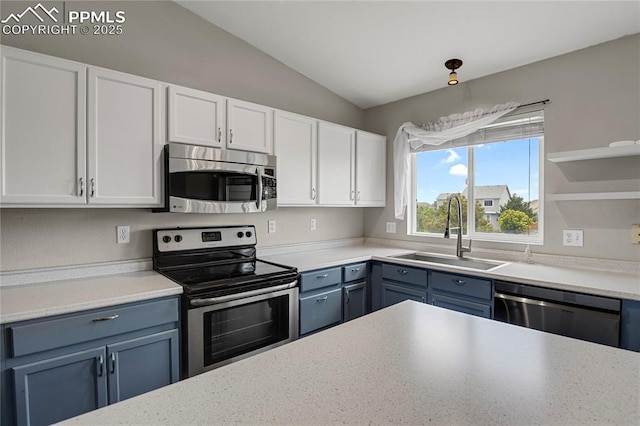 9344 Hirono Rd, Peyton, CO 80831 - kitchen with stainless steel appliances, vaulted ceiling, white cabinetry, light countertops, and blue cabinetry