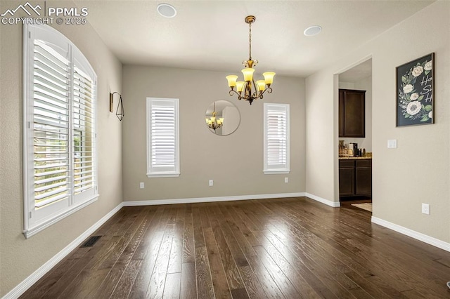 6808 Black Saddle Dr, Colorado Springs, CO 80924 - unfurnished room featuring a chandelier, healthy amount of natural light, and dark wood-style flooring