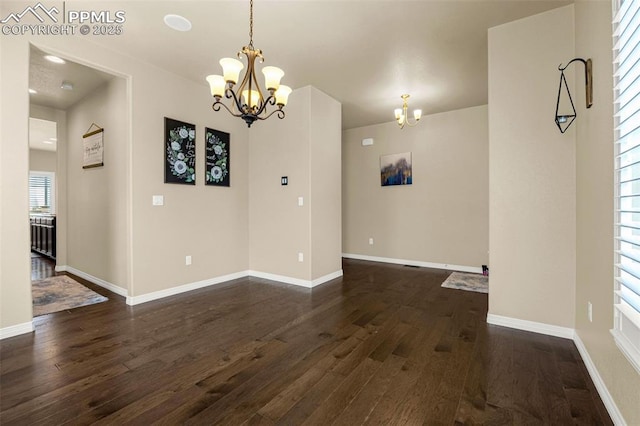 6808 Black Saddle Dr, Colorado Springs, CO 80924 - unfurnished dining area with a chandelier and dark wood finished floors