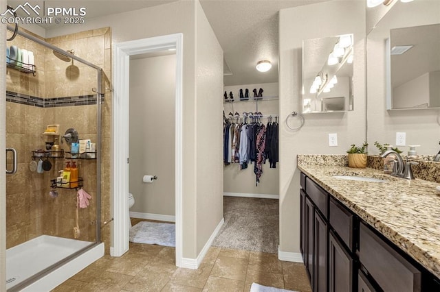 6808 Black Saddle Dr, Colorado Springs, CO 80924 - full bath with vanity, a shower stall, and a spacious closet
