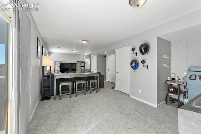 6125 Ashmore Ln, Colorado Springs, CO 80927 - kitchen featuring carpet, a breakfast bar, and an office area