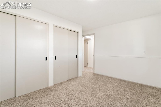 2838 Shadowglen Dr, Colorado Springs, CO 80918 - unfurnished bedroom featuring carpet floors and two closets