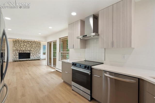 702 Crown Ridge Dr, Colorado Springs, CO 80904 - kitchen featuring stainless steel appliances, wall chimney exhaust hood, modern cabinets, light countertops, and recessed lighting
