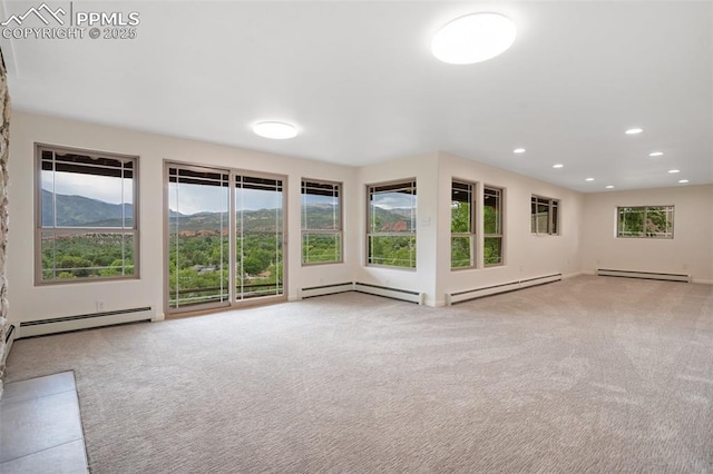 702 Crown Ridge Dr, Colorado Springs, CO 80904 - unfurnished living room with a baseboard heating unit, carpet floors, and recessed lighting