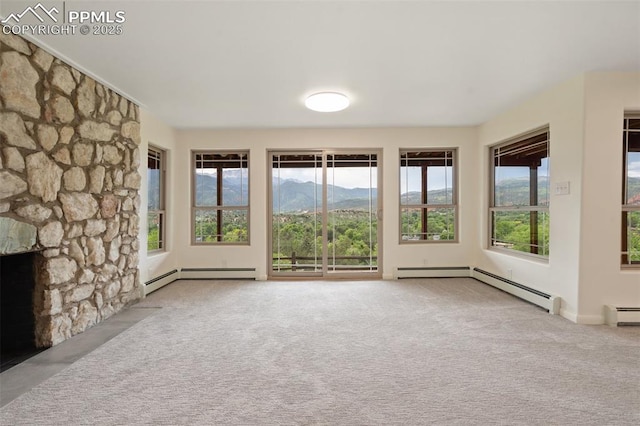 702 Crown Ridge Dr, Colorado Springs, CO 80904 - unfurnished living room with carpet floors, baseboard heating, and a mountain view