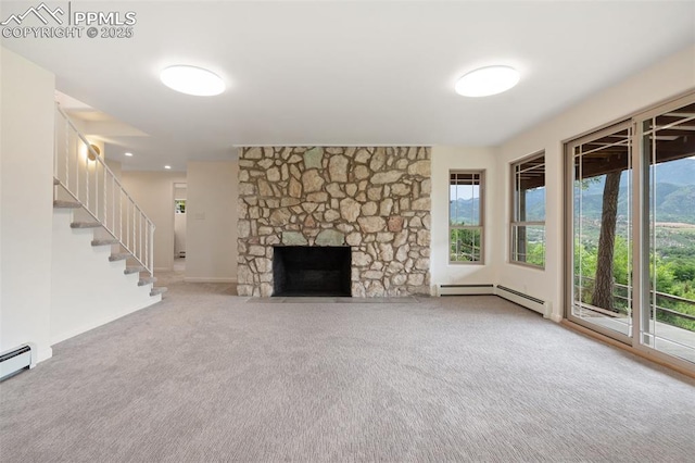 702 Crown Ridge Dr, Colorado Springs, CO 80904 - unfurnished living room featuring carpet floors, a baseboard heating unit, healthy amount of natural light, and stairway