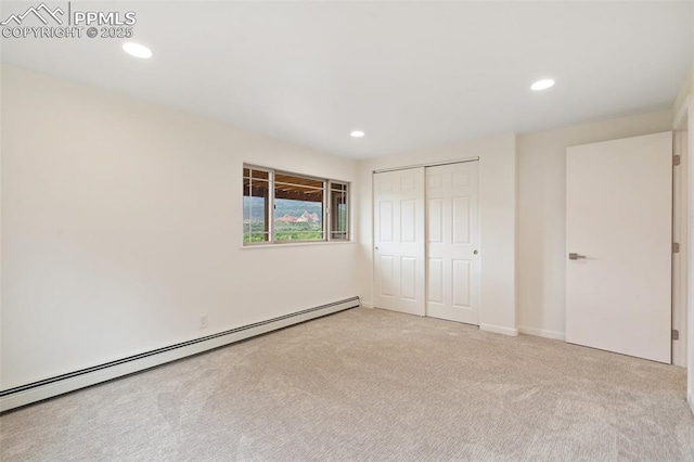 702 Crown Ridge Dr, Colorado Springs, CO 80904 - unfurnished bedroom featuring carpet flooring, a baseboard radiator, recessed lighting, and a closet