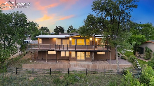 702 Crown Ridge Dr, Colorado Springs, CO 80904 - rear view of house featuring a patio area, a wooden deck, and a fenced backyard