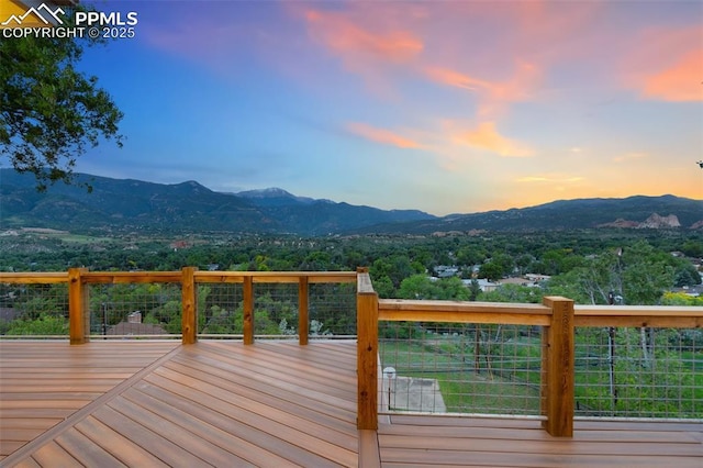 702 Crown Ridge Dr, Colorado Springs, CO 80904 - deck at dusk featuring a mountain view