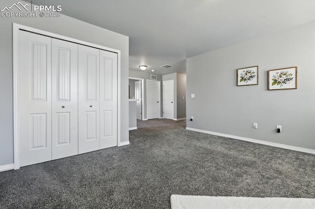 7791 Berwyn Loop, Peyton, CO 80831 - unfurnished bedroom with dark colored carpet and a closet