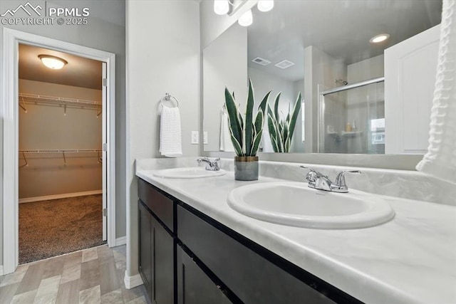 7791 Berwyn Loop, Peyton, CO 80831 - full bath featuring a shower stall, double vanity, and a walk in closet
