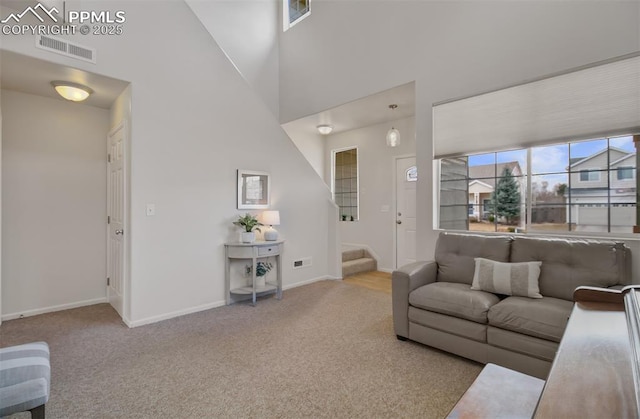 5128 Mountain Air Cir, Colorado Springs, CO 80916 - living area with carpet floors, stairs, and a towering ceiling