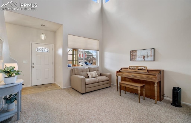5128 Mountain Air Cir, Colorado Springs, CO 80916 - carpeted entrance foyer featuring a towering ceiling and baseboards