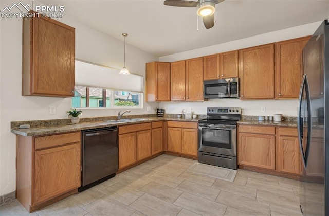 5128 Mountain Air Cir, Colorado Springs, CO 80916 - kitchen featuring appliances with stainless steel finishes, brown cabinetry, dark countertops, and a ceiling fan