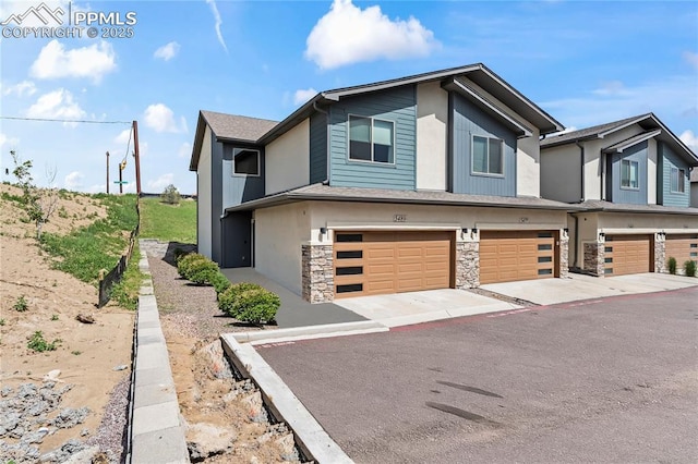 5489 Passport Vw, Colorado Springs, CO 80922 - view of property with an attached garage and stone siding