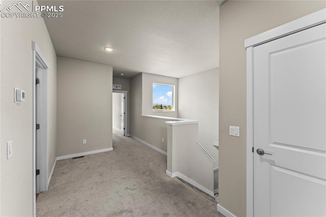 5489 Passport Vw, Colorado Springs, CO 80922 - hall featuring an upstairs landing, carpet flooring, a textured ceiling, and recessed lighting
