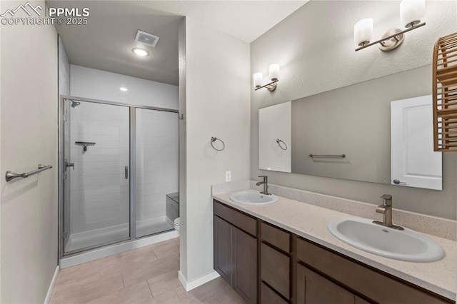 5489 Passport Vw, Colorado Springs, CO 80922 - bathroom featuring a stall shower, double vanity, and tile patterned flooring