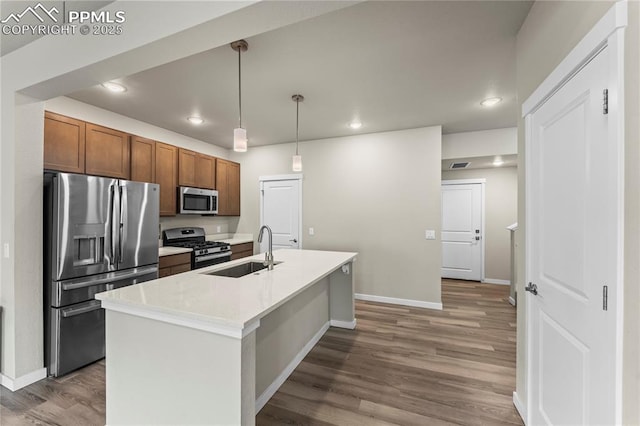 5489 Passport Vw, Colorado Springs, CO 80922 - kitchen featuring stainless steel appliances, recessed lighting, wood finished floors, light countertops, and pendant lighting