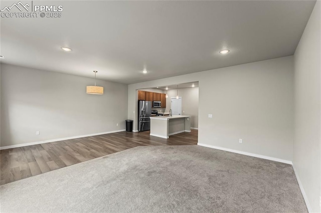 5489 Passport Vw, Colorado Springs, CO 80922 - unfurnished living room featuring dark carpet, recessed lighting, and dark wood finished floors