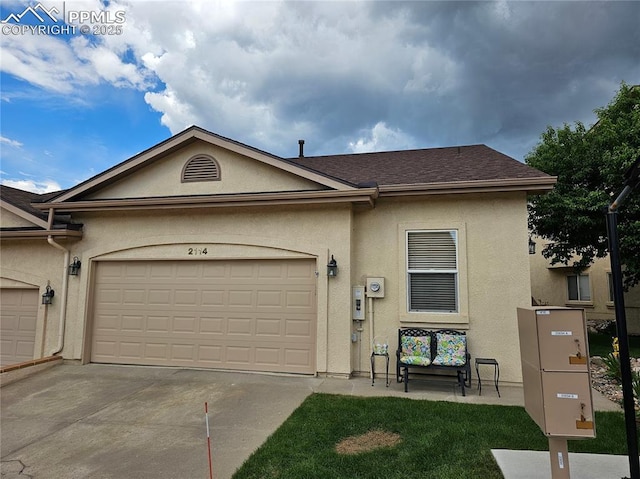 2114 Summerset Dr, Colorado Springs, CO 80920 - view of front of house with stucco siding, concrete driveway, an attached garage, and roof with shingles