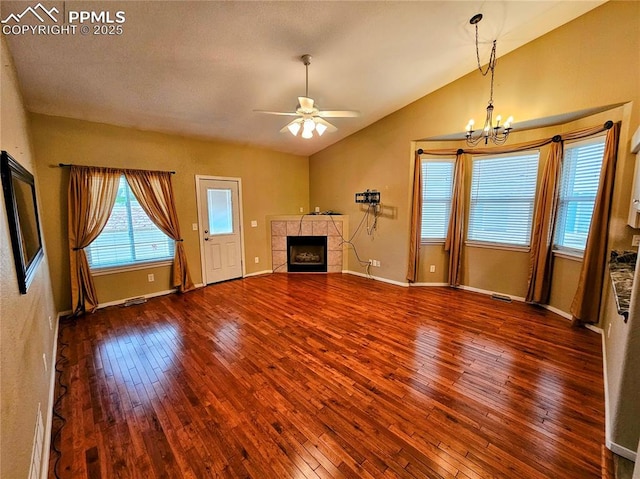 2114 Summerset Dr, Colorado Springs, CO 80920 - unfurnished living room featuring a tile fireplace, wood-type flooring, a chandelier, a ceiling fan, and lofted ceiling