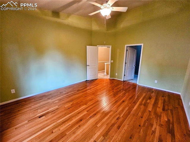 2114 Summerset Dr, Colorado Springs, CO 80920 - spare room featuring a towering ceiling, wood finished floors, and a ceiling fan