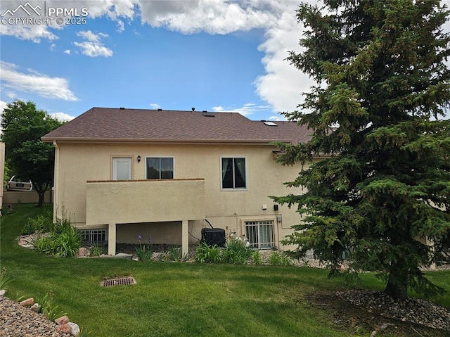 2114 Summerset Dr, Colorado Springs, CO 80920 - rear view of property with stucco siding and a yard
