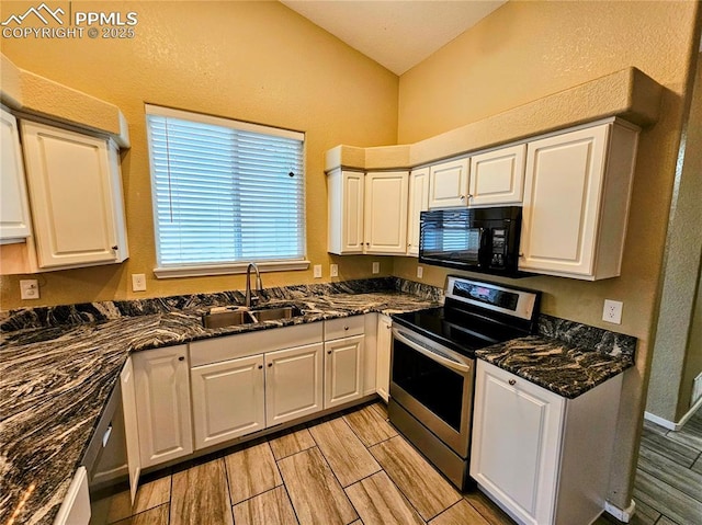 2114 Summerset Dr, Colorado Springs, CO 80920 - kitchen featuring black microwave, stainless steel electric range oven, wood tiled floors, white cabinetry, and lofted ceiling