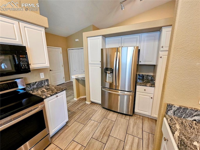 2114 Summerset Dr, Colorado Springs, CO 80920 - kitchen with appliances with stainless steel finishes, vaulted ceiling, white cabinets, wood tiled floors, and dark stone countertops