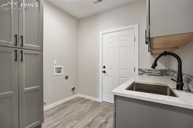 5115 Vista Del Norte Pt, Colorado Springs, CO 80919 - washroom featuring cabinet space, light wood-style floors, hookup for an electric dryer, and washer hookup