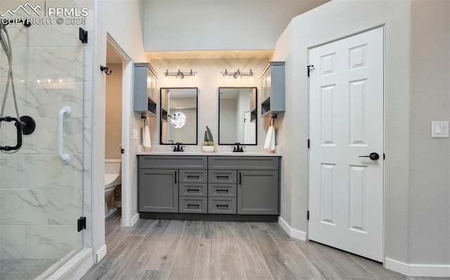 5115 Vista Del Norte Pt, Colorado Springs, CO 80919 - full bath featuring double vanity, a marble finish shower, and wood finished floors