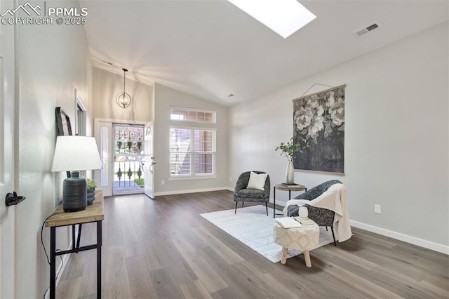 5115 Vista Del Norte Pt, Colorado Springs, CO 80919 - sitting room with wood finished floors, vaulted ceiling, and a skylight