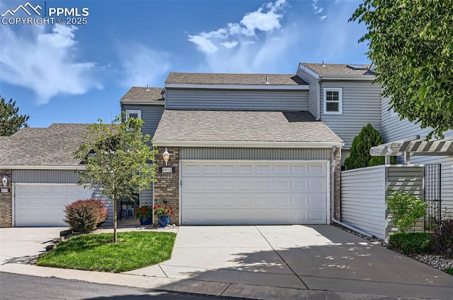 2512 Elite Ter, Colorado Springs, CO 80920 - traditional-style house with brick siding, a garage, and concrete driveway