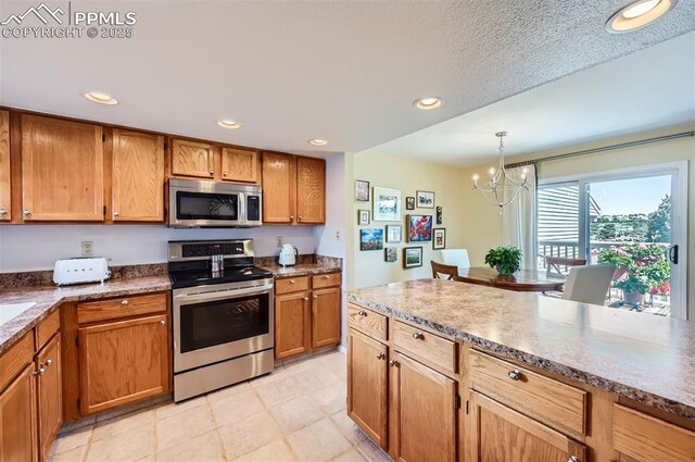 2512 Elite Ter, Colorado Springs, CO 80920 - kitchen featuring stainless steel appliances, a chandelier, recessed lighting, brown cabinetry, and hanging light fixtures
