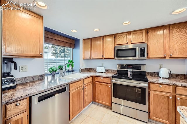 2512 Elite Ter, Colorado Springs, CO 80920 - kitchen with stainless steel appliances, recessed lighting, stone counters, and light tile patterned floors