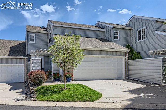 2512 Elite Ter, Colorado Springs, CO 80920 - view of front of home featuring concrete driveway, roof with shingles, a garage, and a pergola