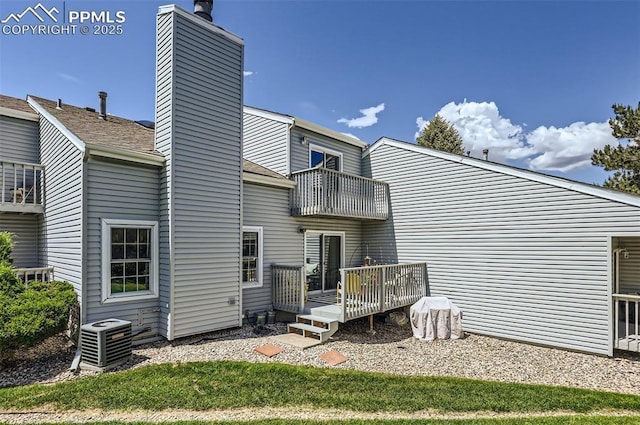 2512 Elite Ter, Colorado Springs, CO 80920 - back of house with a balcony, a chimney, and a wooden deck