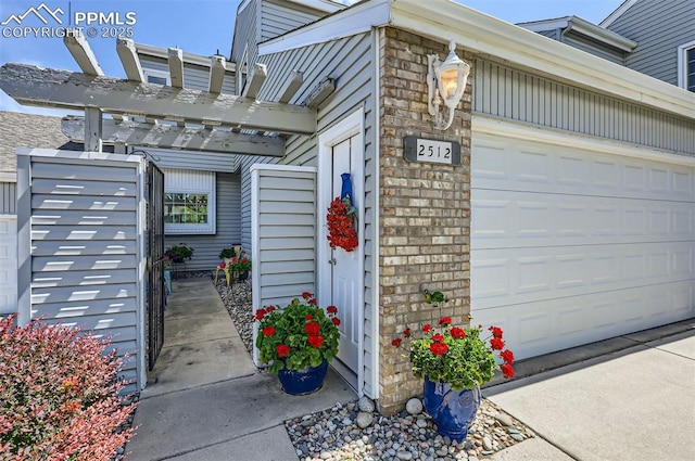 2512 Elite Ter, Colorado Springs, CO 80920 - view of exterior entry with an attached garage and a pergola