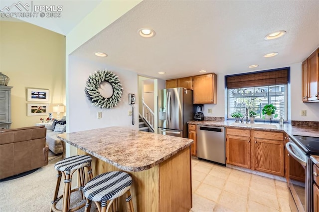 2512 Elite Ter, Colorado Springs, CO 80920 - kitchen featuring stainless steel appliances, a kitchen bar, recessed lighting, a center island, and open floor plan