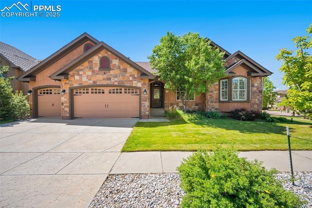 1117 Spectrum Loop, Colorado Springs, CO 80921 - view of front of property with an attached garage, concrete driveway, a front lawn, and stone siding
