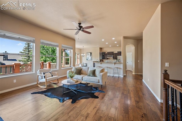 1117 Spectrum Loop, Colorado Springs, CO 80921 - living room with a ceiling fan, dark wood-type flooring, arched walkways, and recessed lighting