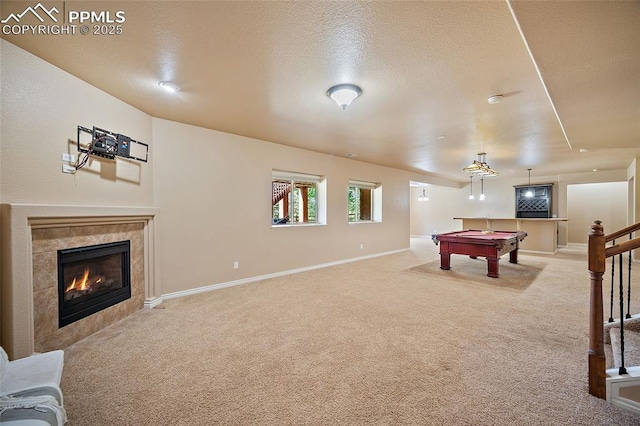 1117 Spectrum Loop, Colorado Springs, CO 80921 - playroom with light colored carpet, billiards table, a fireplace, and a textured ceiling