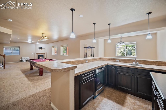 1117 Spectrum Loop, Colorado Springs, CO 80921 - kitchen featuring dishwasher, healthy amount of natural light, open floor plan, and a textured ceiling
