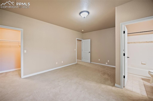 1117 Spectrum Loop, Colorado Springs, CO 80921 - unfurnished bedroom with a walk in closet, carpet floors, and a closet