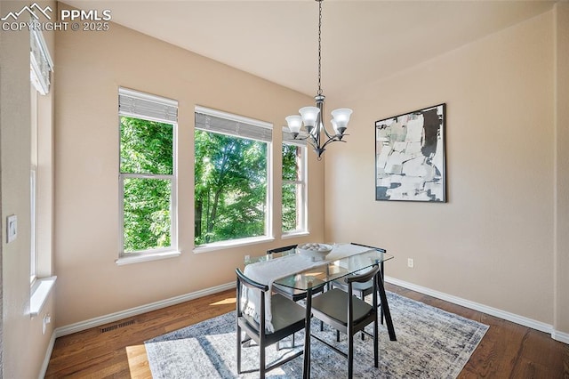 1117 Spectrum Loop, Colorado Springs, CO 80921 - dining room with healthy amount of natural light, a chandelier, and dark wood-style flooring