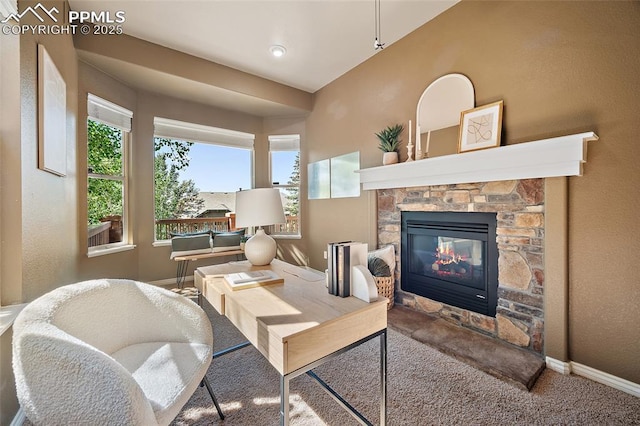 1117 Spectrum Loop, Colorado Springs, CO 80921 - carpeted living room featuring healthy amount of natural light and a stone fireplace
