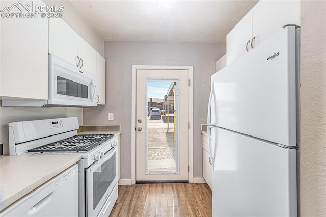 3210 Van Teylingen Dr Unit E, Colorado Springs, CO 80917 - kitchen featuring white appliances, light wood-type flooring, white cabinets, and light countertops
